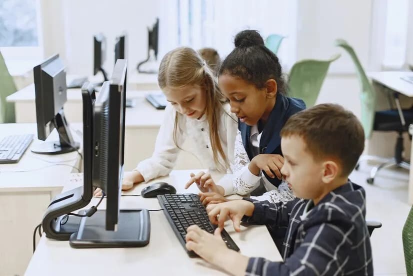 three students using computer